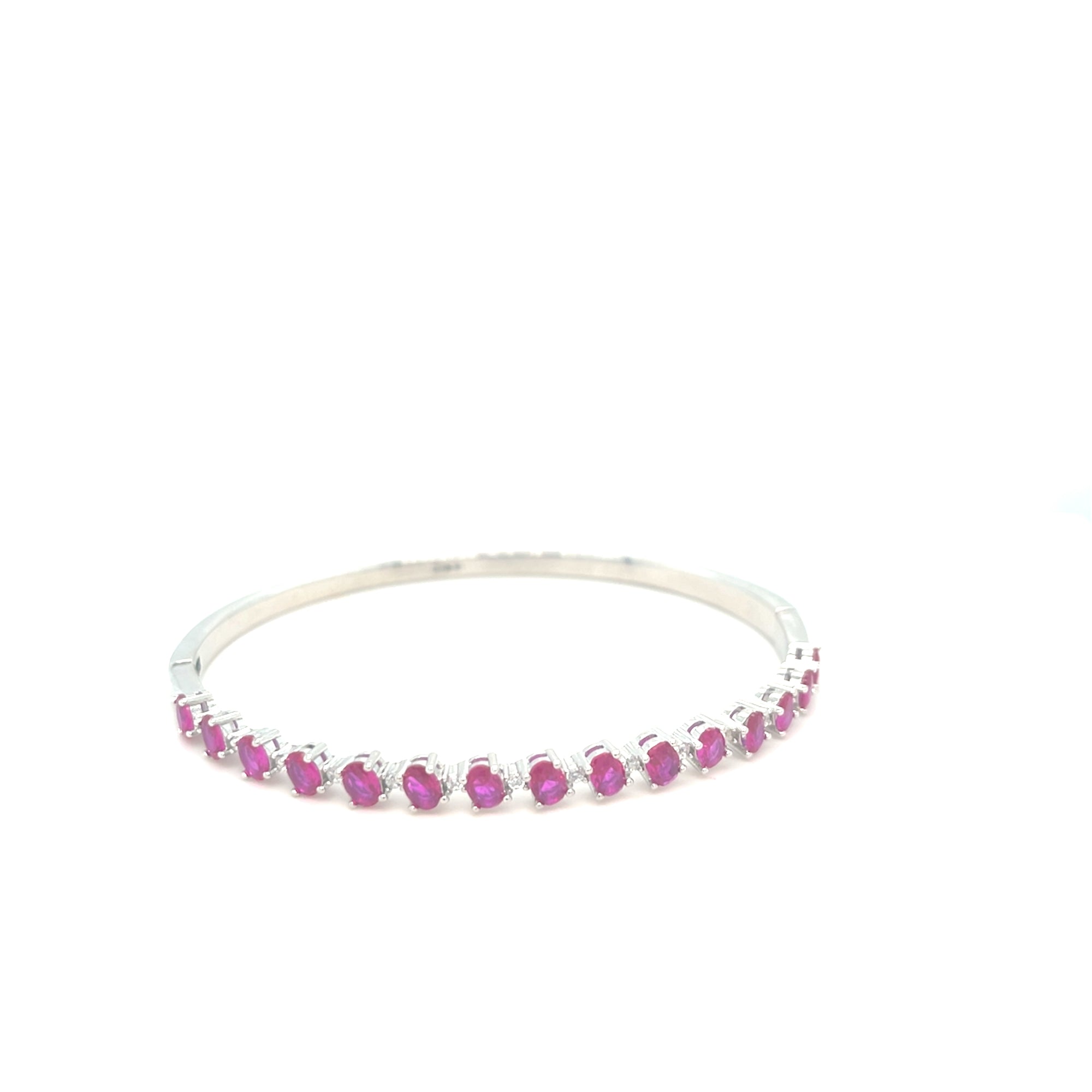Sterling silver bangle with ruby coloured stones
