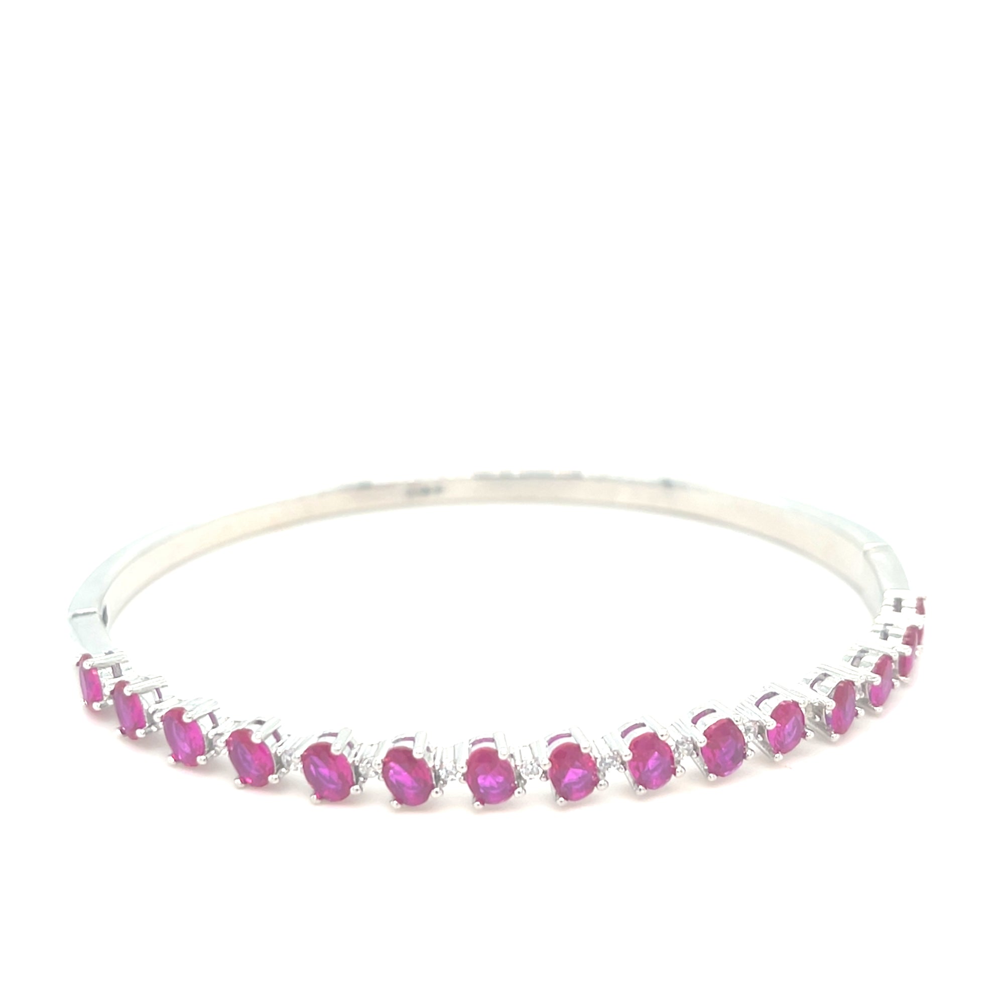 Sterling silver bangle with ruby coloured stones