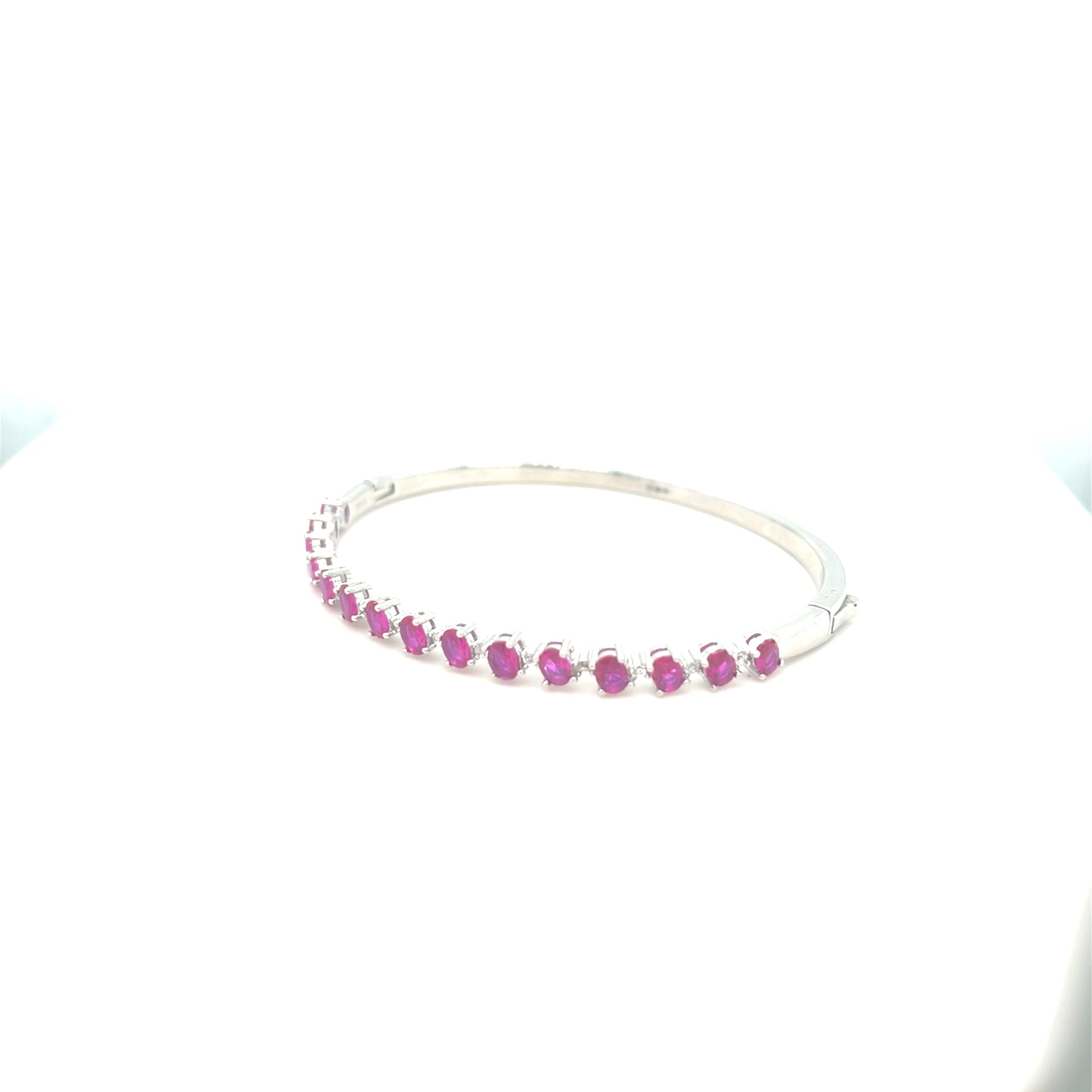 Sterling silver bangle with ruby coloured stones