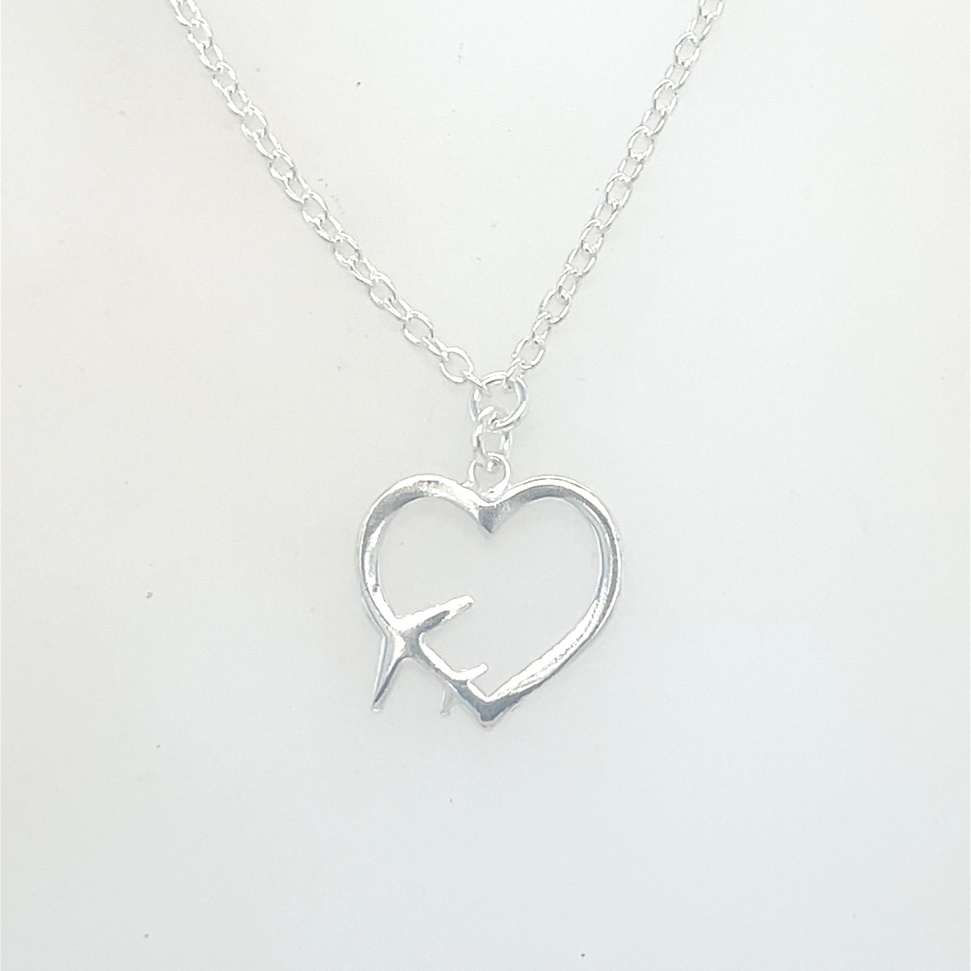 Sterling Silver Heart Pendant with Plane Symbol