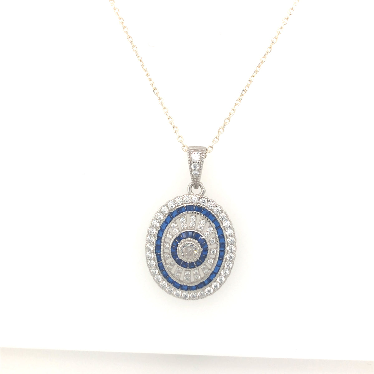 Sterling Silver Stone set Oval Pendant with Sapphire Coloured Stones